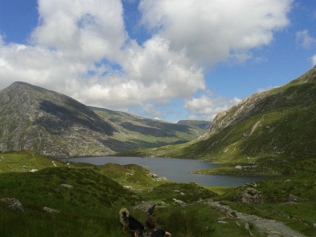Image showing Snowdonia and peaks of various mountains amidst a backdrop of blue sky and white clouds.